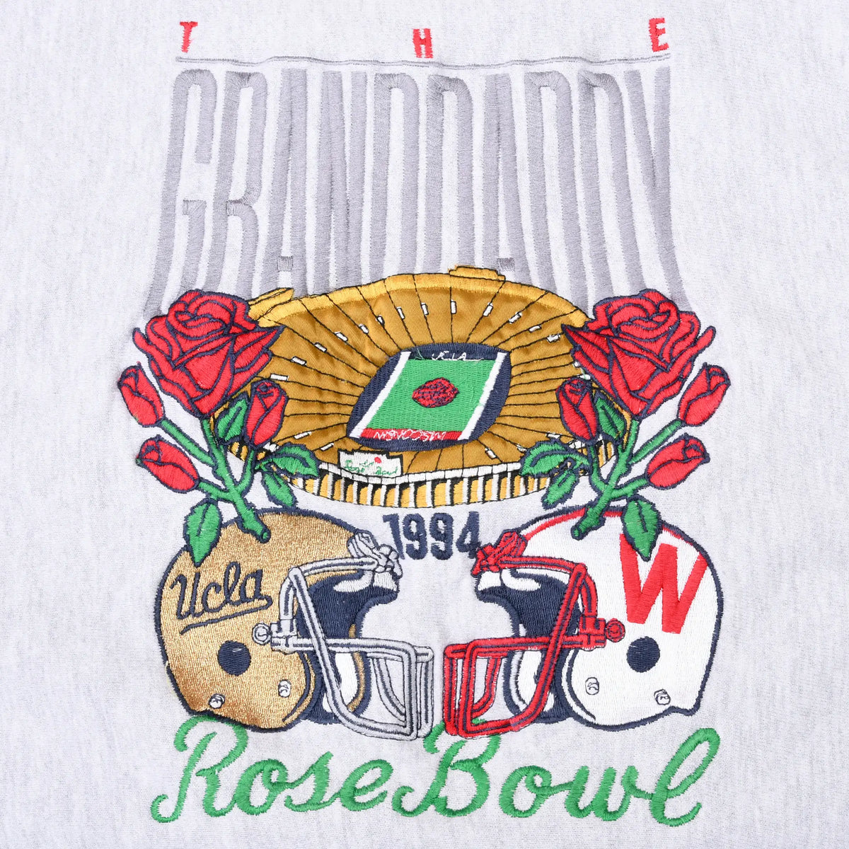 Close-up of 1994 UCLA-Wisconsin Rose Bowl embroidery with helmets, roses, and stadium
