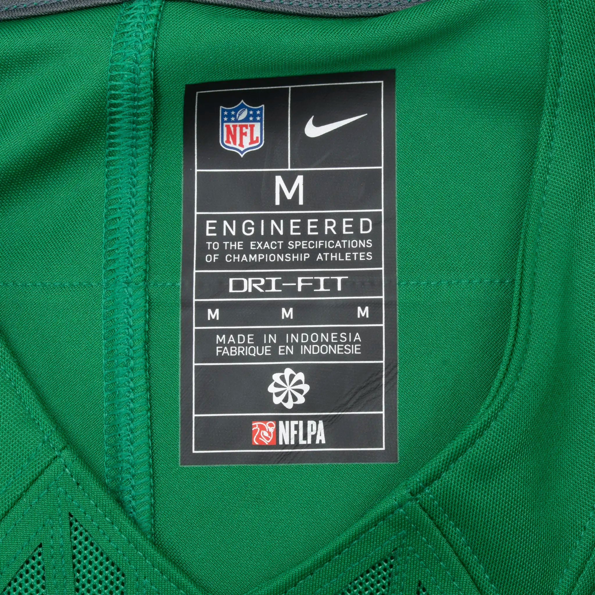 Interior Nike NFL Dri-FIT neck label marked size M on green jersey