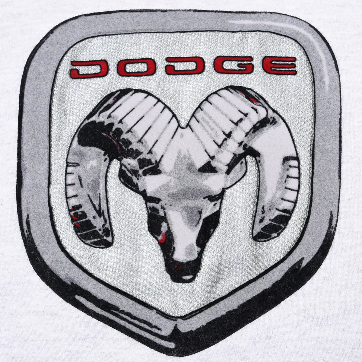 Close-up of silver, black, and red Dodge ram logo patch