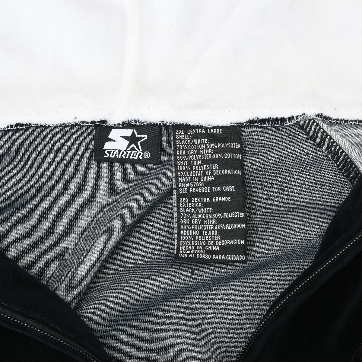 Starter neck and care labels inside black hoodie marked 2X extra large