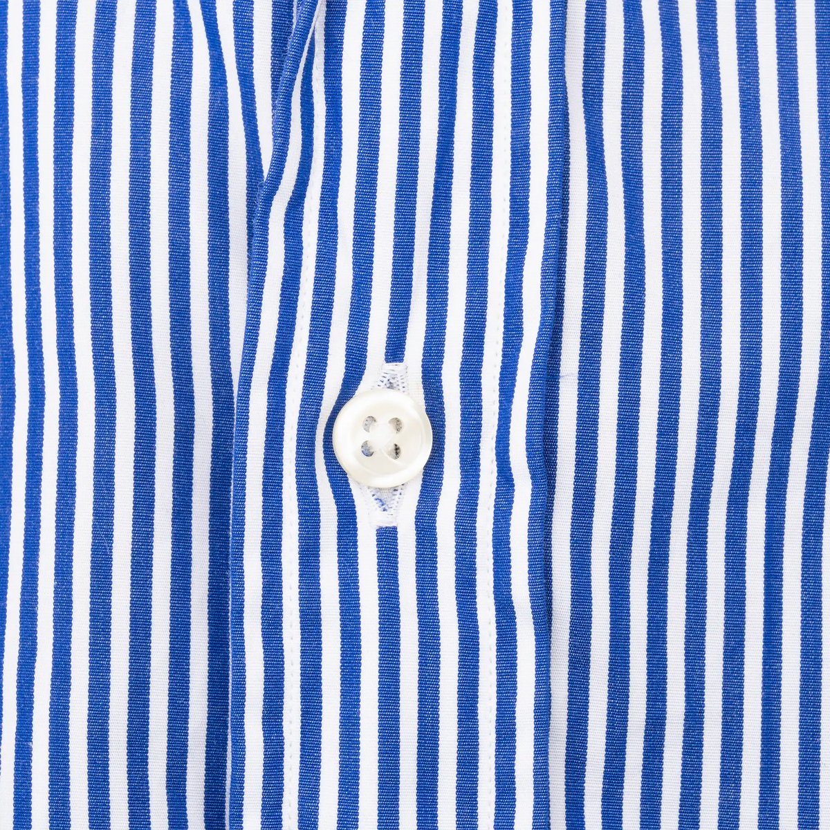 Close-up of white button and placket on blue striped Ralph Lauren shirt