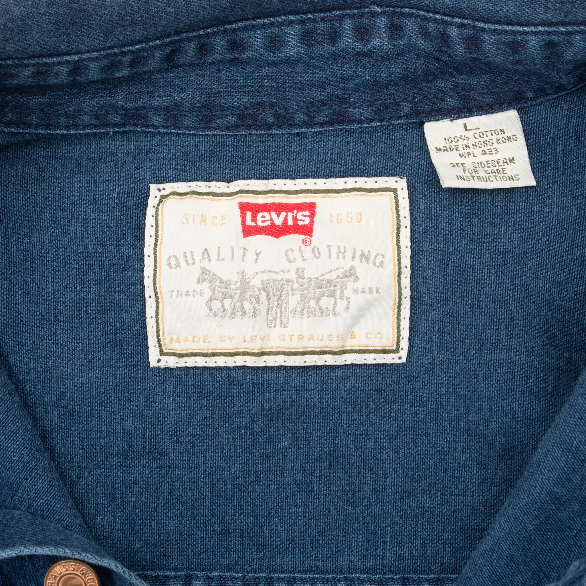 Levi's neck label and care tag inside blue denim shirt