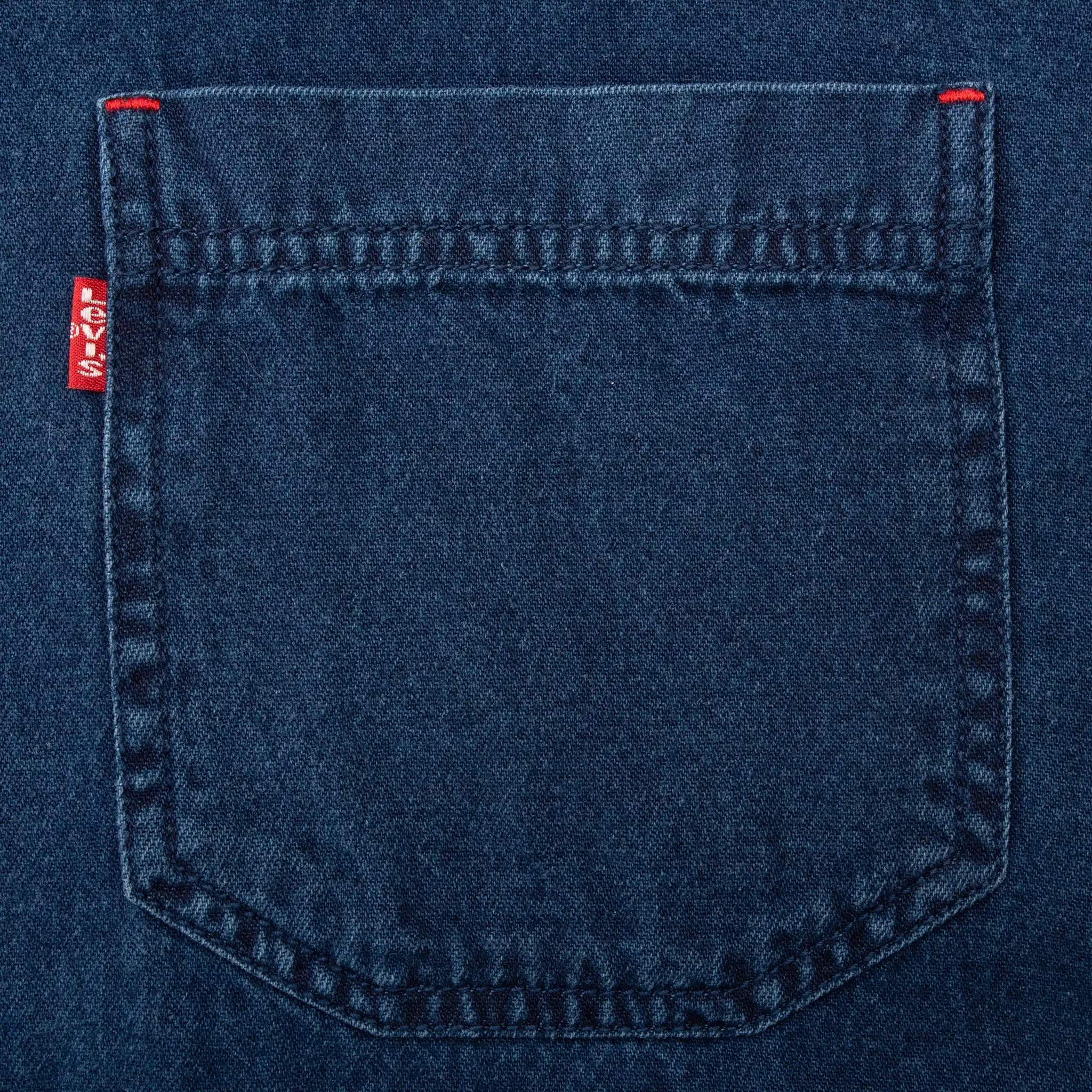 Close-up of blue denim chest pocket with red Levi's tab