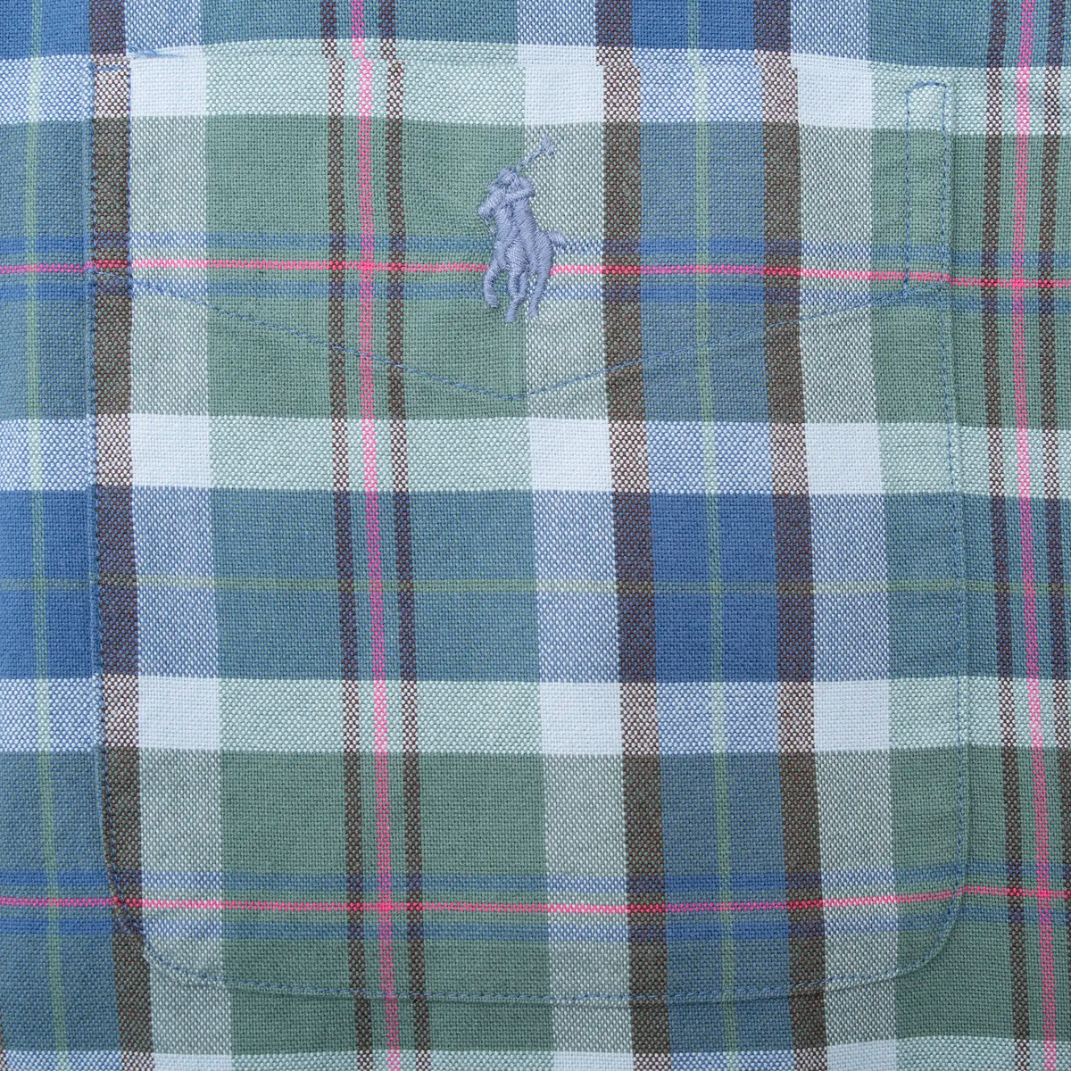 Polo pony chest embroidery detail on blue and green plaid fabric