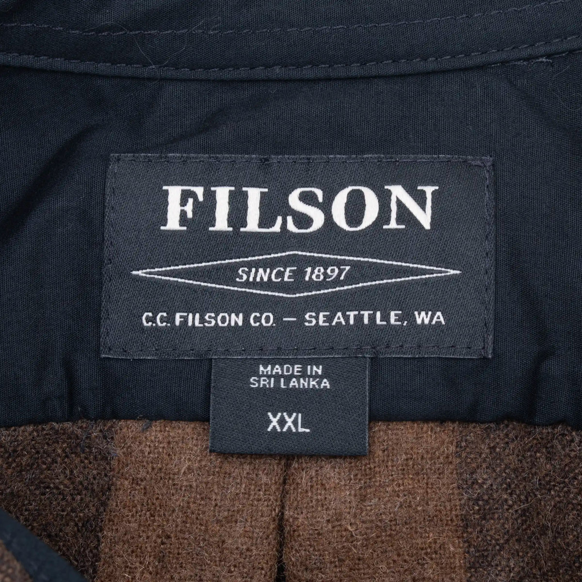 Filson neck label and XXL size tag inside plaid flannel shirt