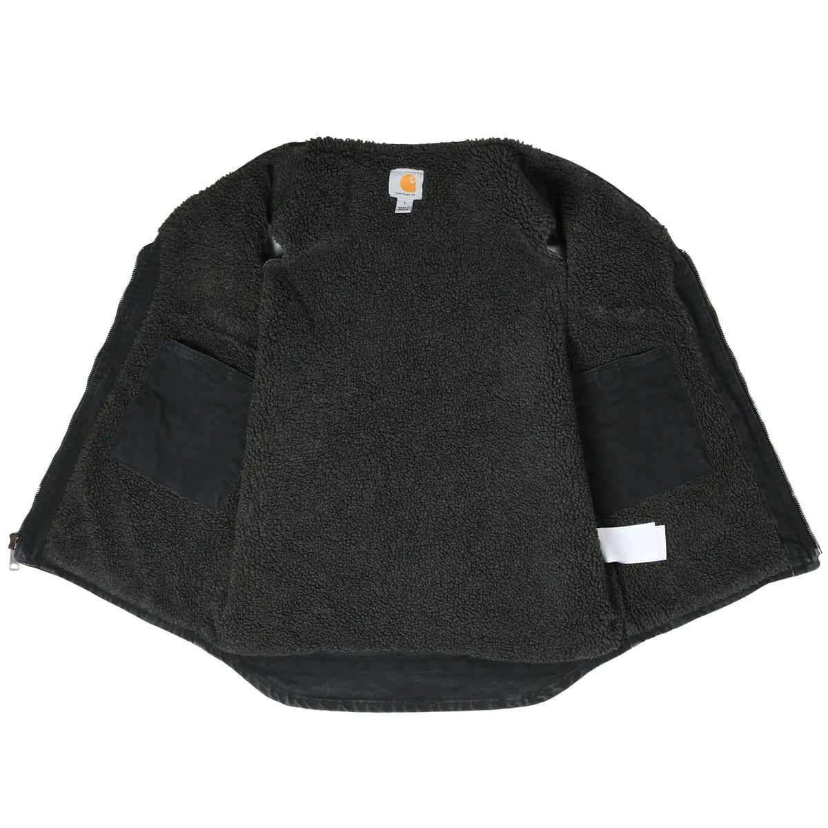 Open Carhartt vest showing black sherpa lining and interior pockets