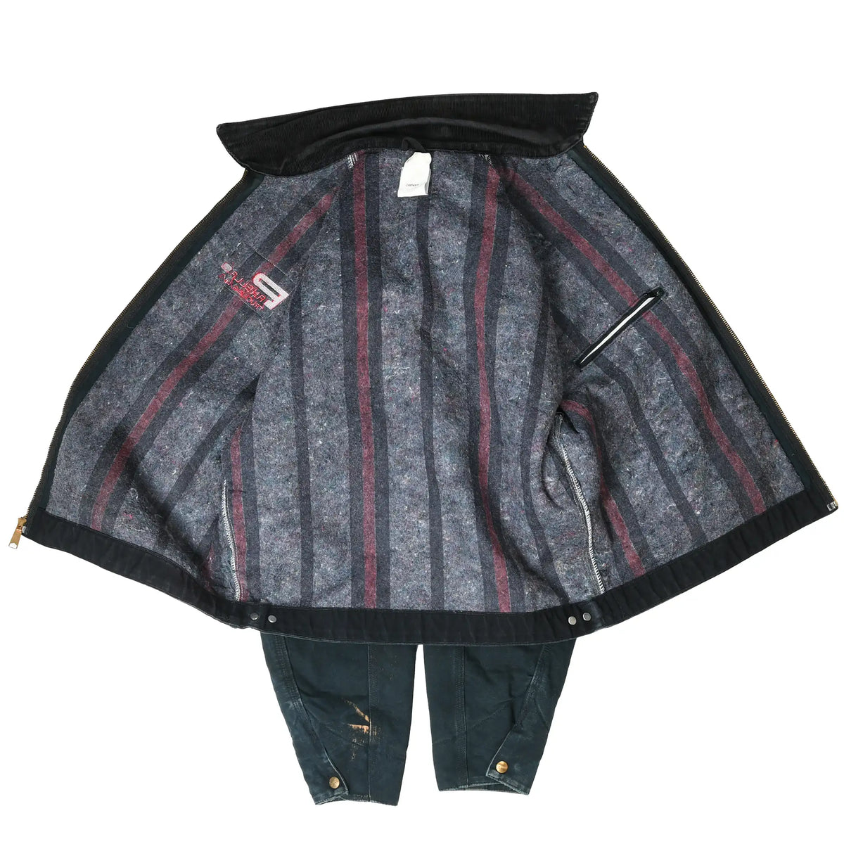 Open black Carhartt Detroit jacket showing gray blanket lining with red stripes