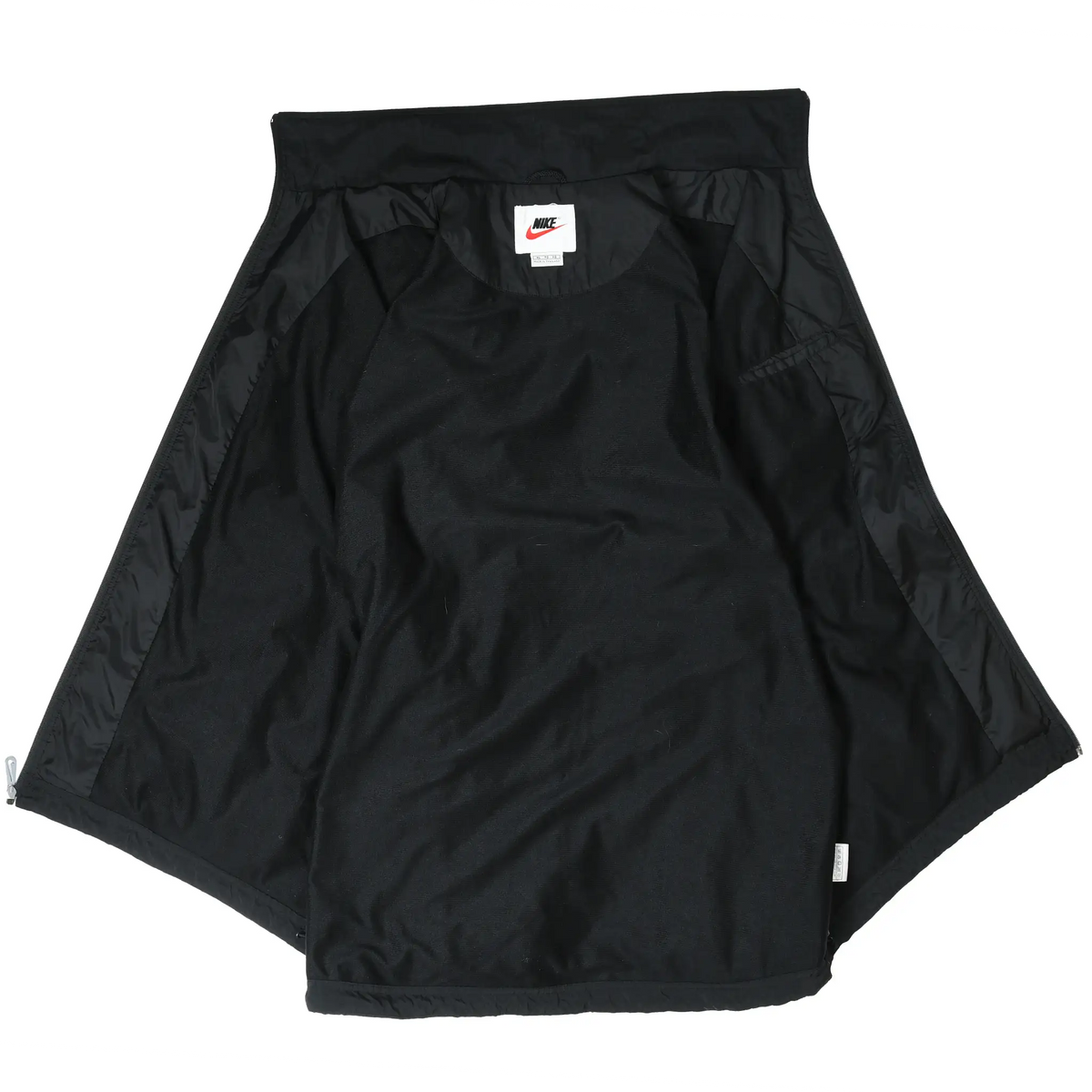 Interior of black Nike windbreaker jacket showing lining and neck label