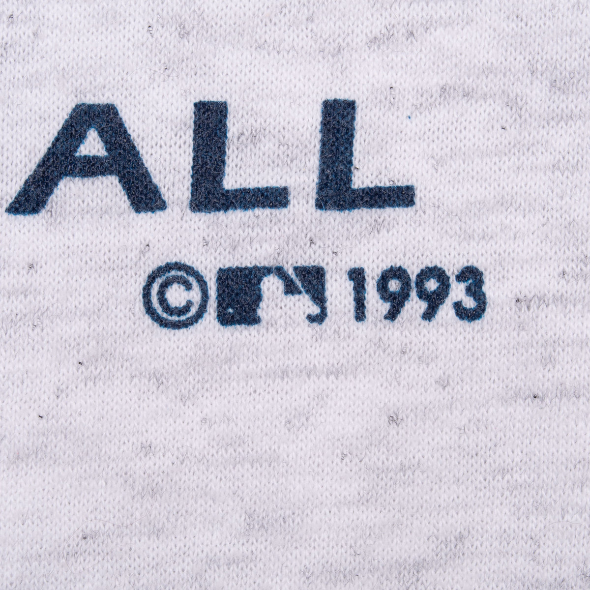 Close-up of MLB copyright 1993 print on gray T-shirt fabric