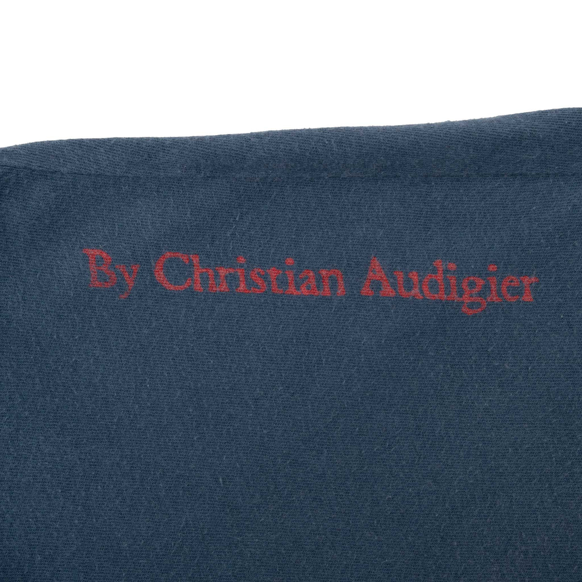 Close-up of red By Christian Audigier sleeve print