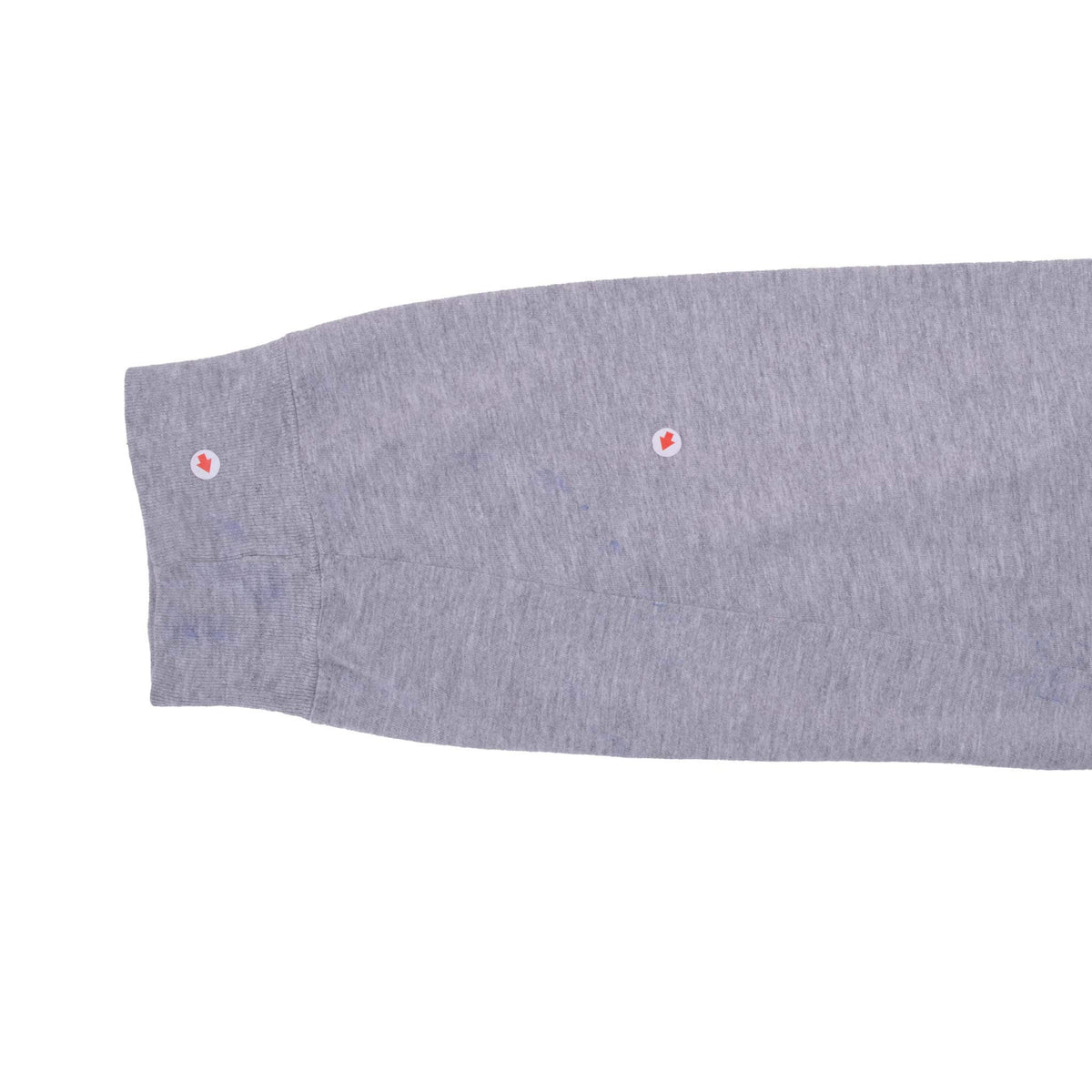 Grey long-sleeve cuff detail with two spots highlighted by red arrow markers