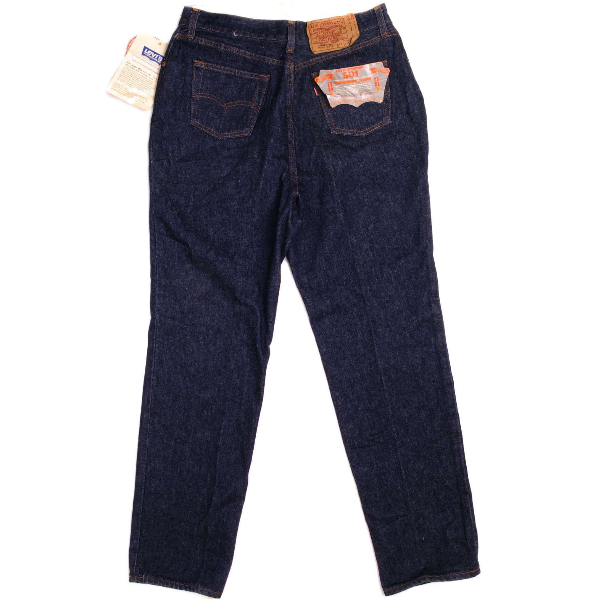 Beautiful Indigo Levis 501 Womenswear Jeans 1980's Made in USA with a very dark wash, deadstock with original tags. Size on Tag 33X30