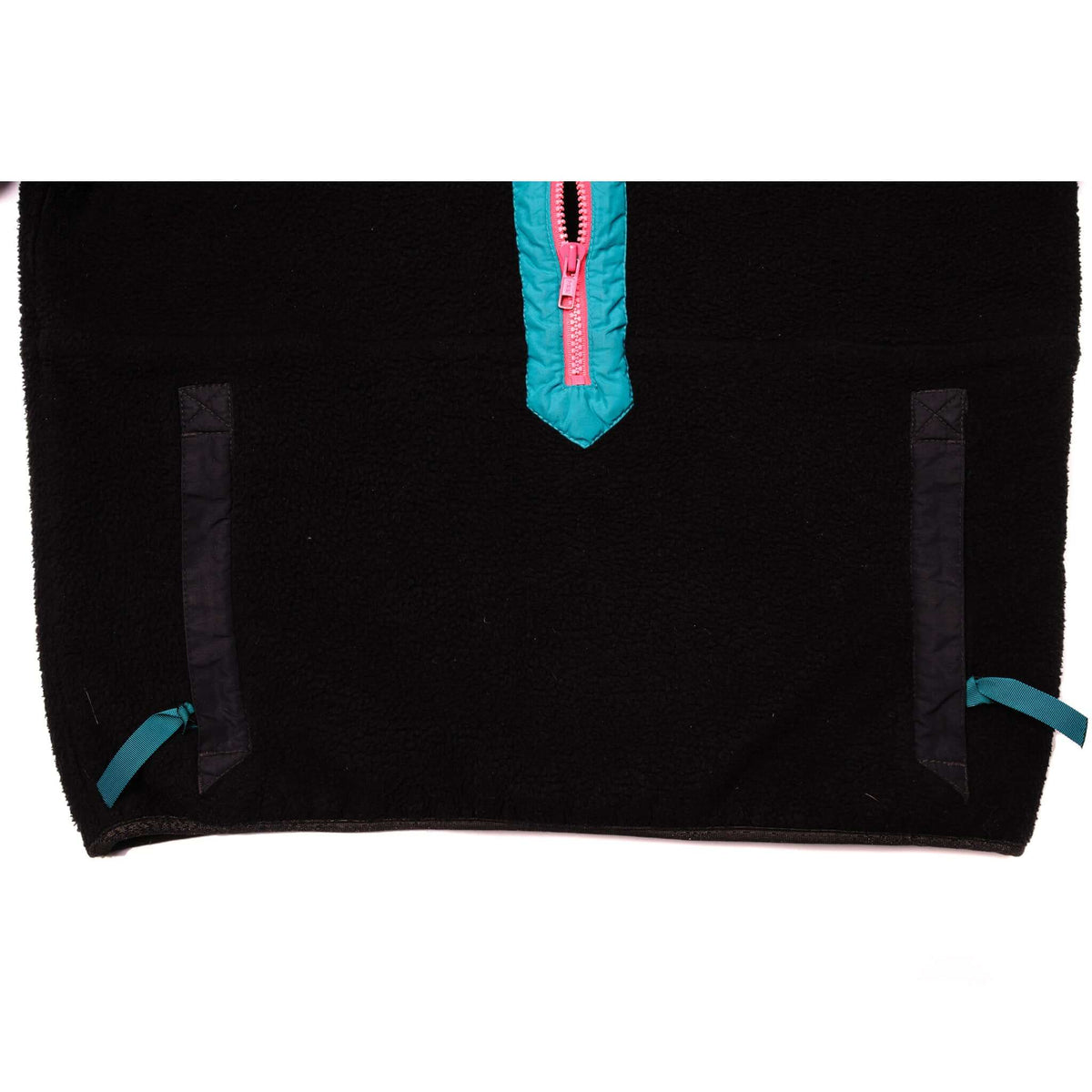 Lower front detail with two pockets, teal tabs, and teal-trimmed pink zipper