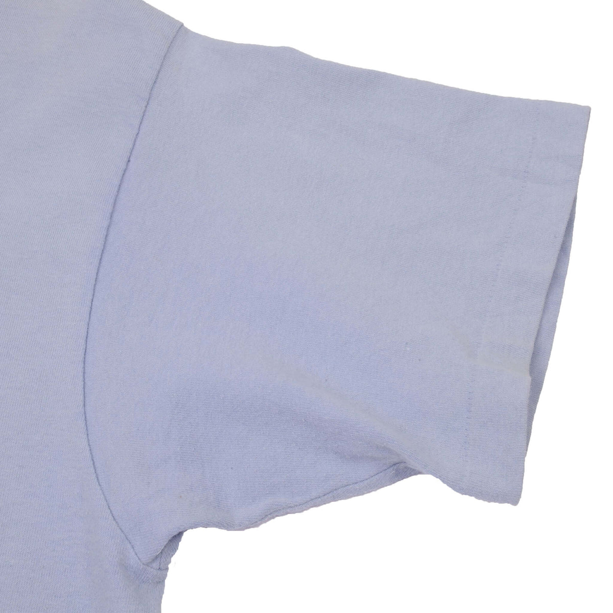 Close-up of light blue T-shirt sleeve and single-stitch hem