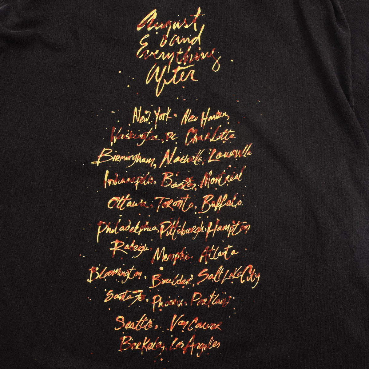 Close-up of August and Everything After tour city list printed on the back
