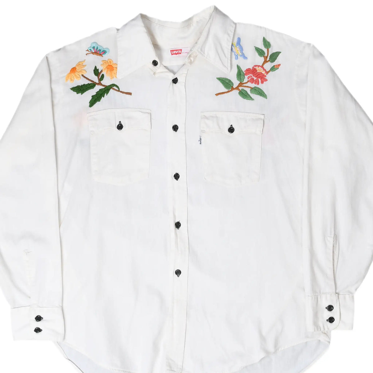 Front of white Levi's button-up shirt with two chest pockets and colorful floral embroidery