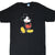 Front of black Disney T-shirt with Mickey Mouse graphic in red shorts and yellow shoes