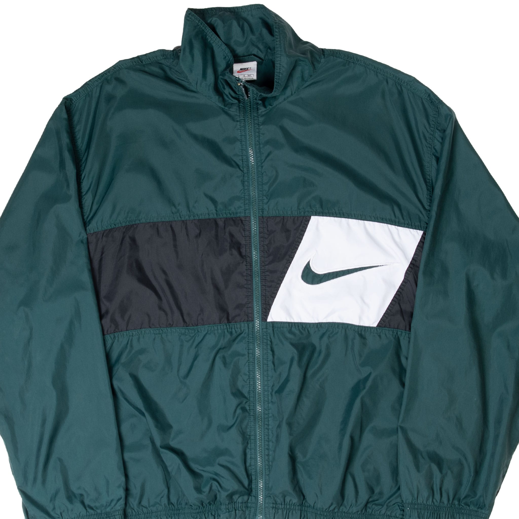 Front detail of green Nike windbreaker with black-and-white chest panel and Swoosh
