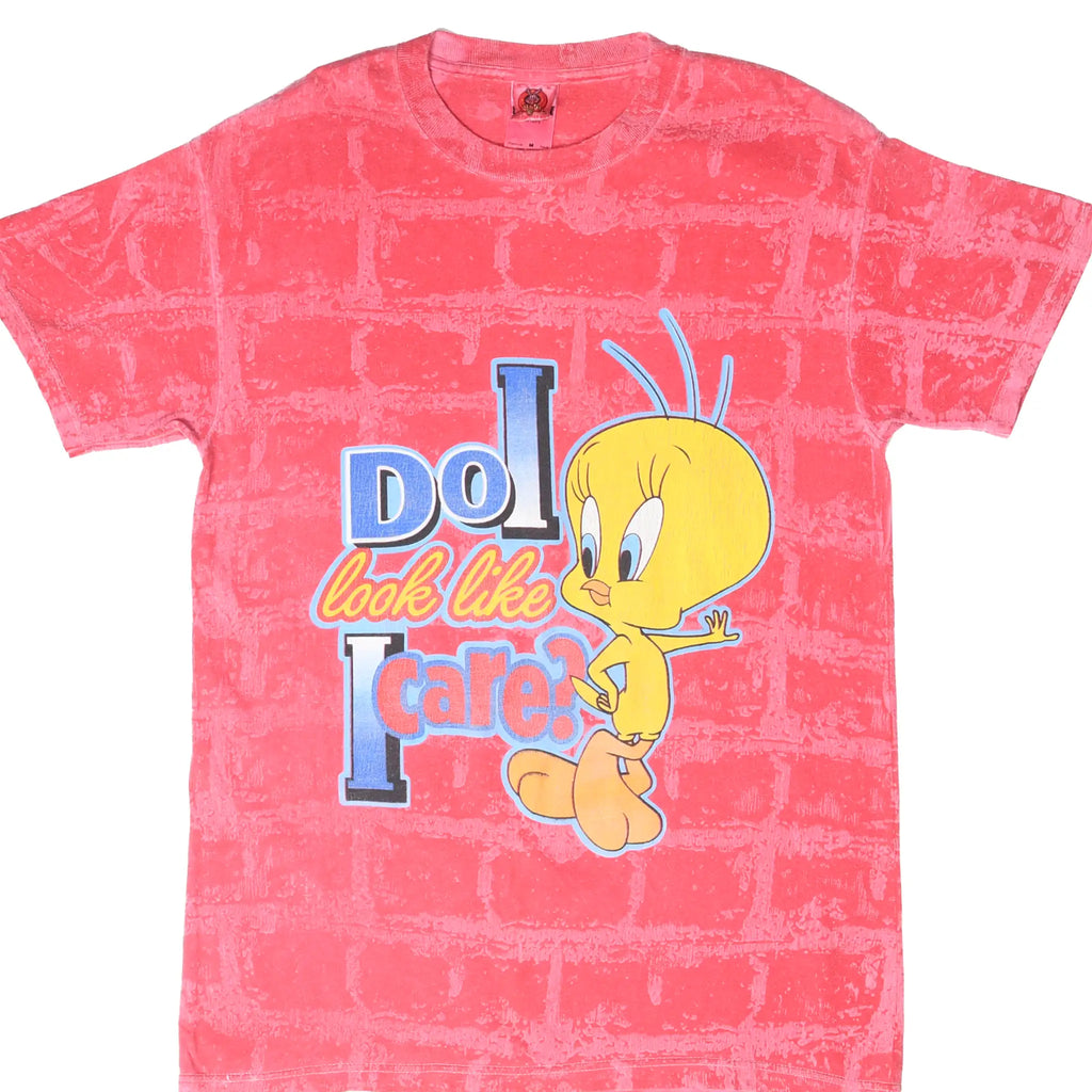 Front of pink brick-pattern Looney Tunes T-shirt with Tweety and Do I Look Like I Care? graphic