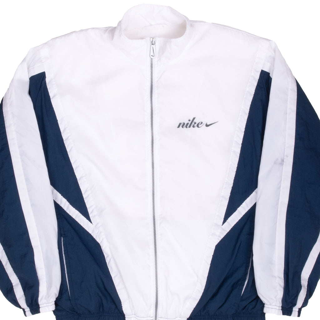 Front close-up of white and navy Nike windbreaker with zip closure and embroidered chest logo