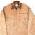 Front detail of brown Carhartt Detroit jacket with corduroy collar and zip pockets