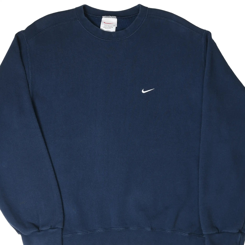 Front close-up of navy blue Nike crewneck sweatshirt with small white Swoosh embroidery