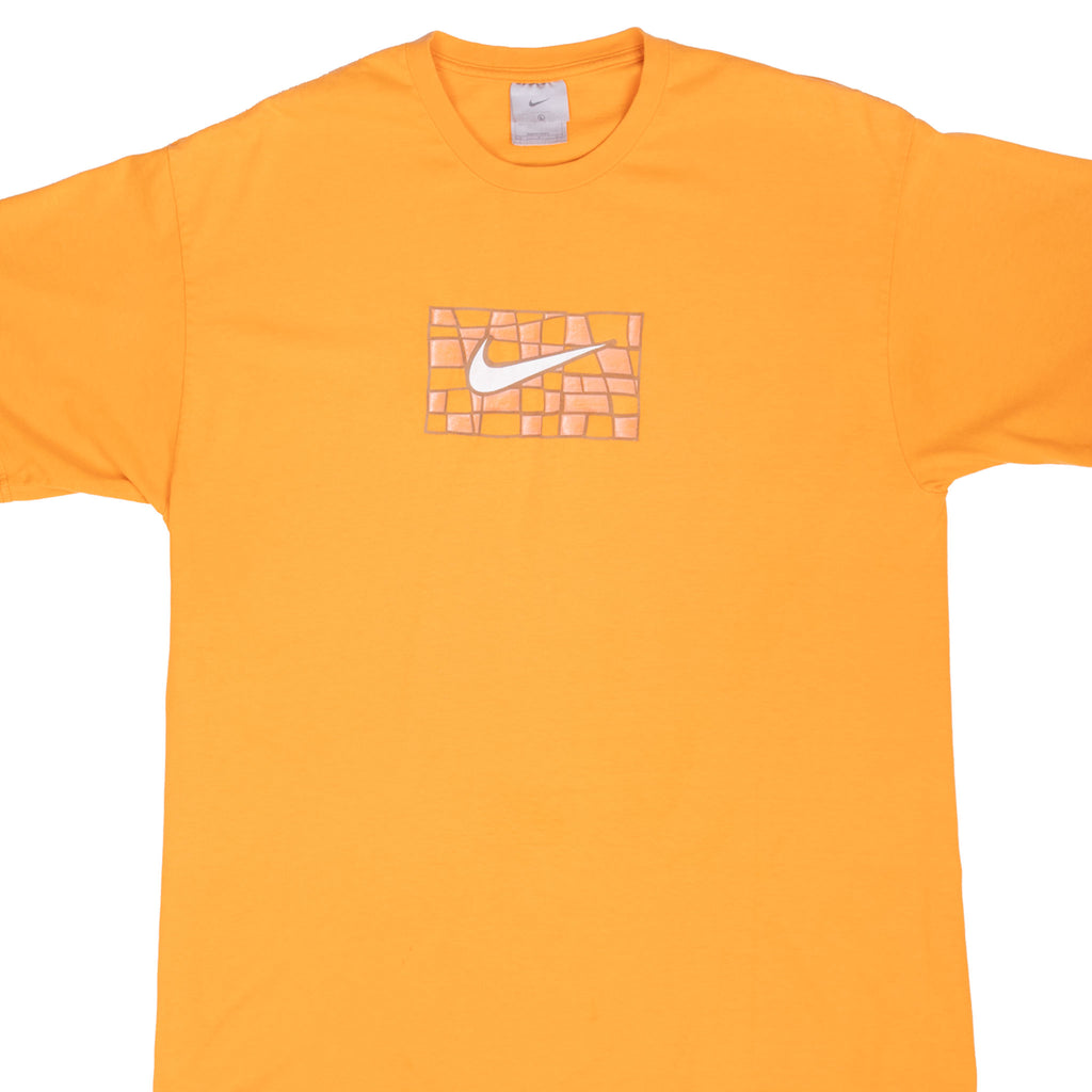 Front upper view of orange Nike T-shirt with white Swoosh and abstract grid graphic