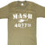 Front of olive green M*A*S*H 4077th T-shirt with white helicopter graphic