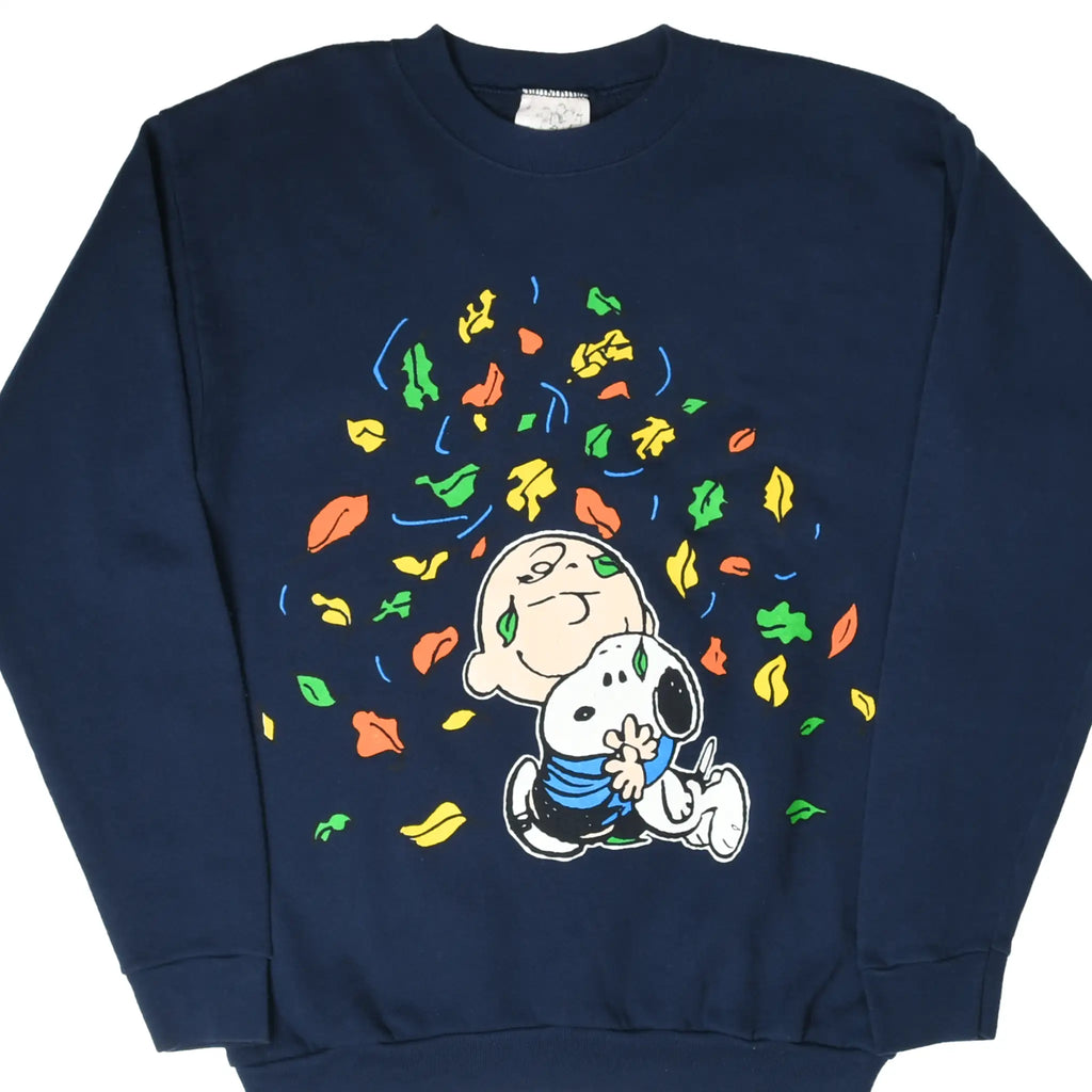 Front of navy Peanuts sweatshirt with Snoopy and Charlie Brown among colorful falling leaves