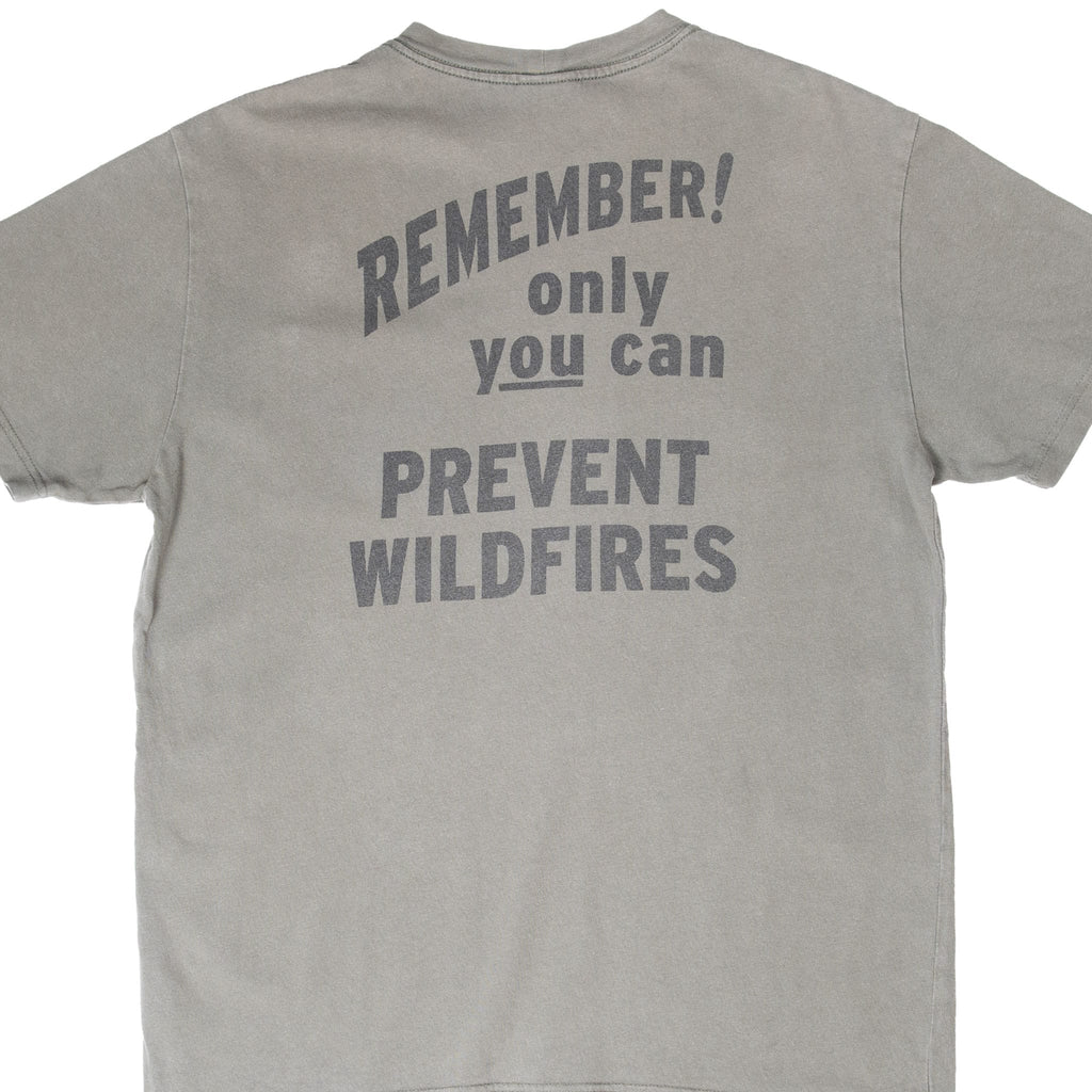 Cropped back of green Filson T-shirt with Only You Can Prevent Wildfires slogan