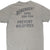 Cropped back of green Filson T-shirt with Only You Can Prevent Wildfires slogan