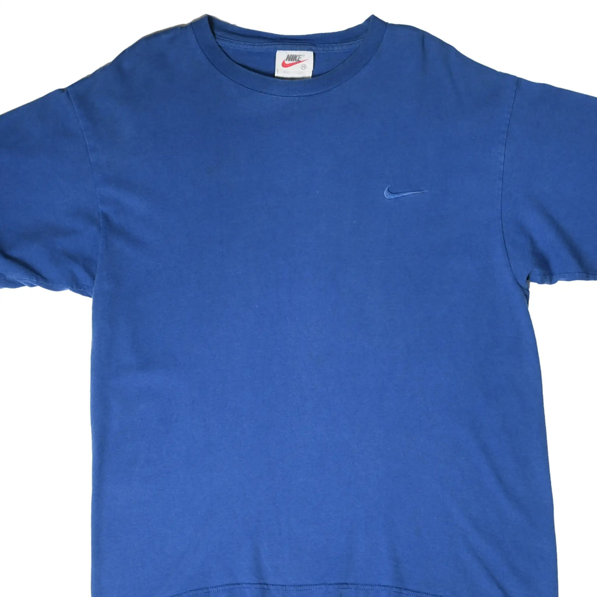 Front close-up of blue Nike T-shirt with tonal embroidered Swoosh on chest