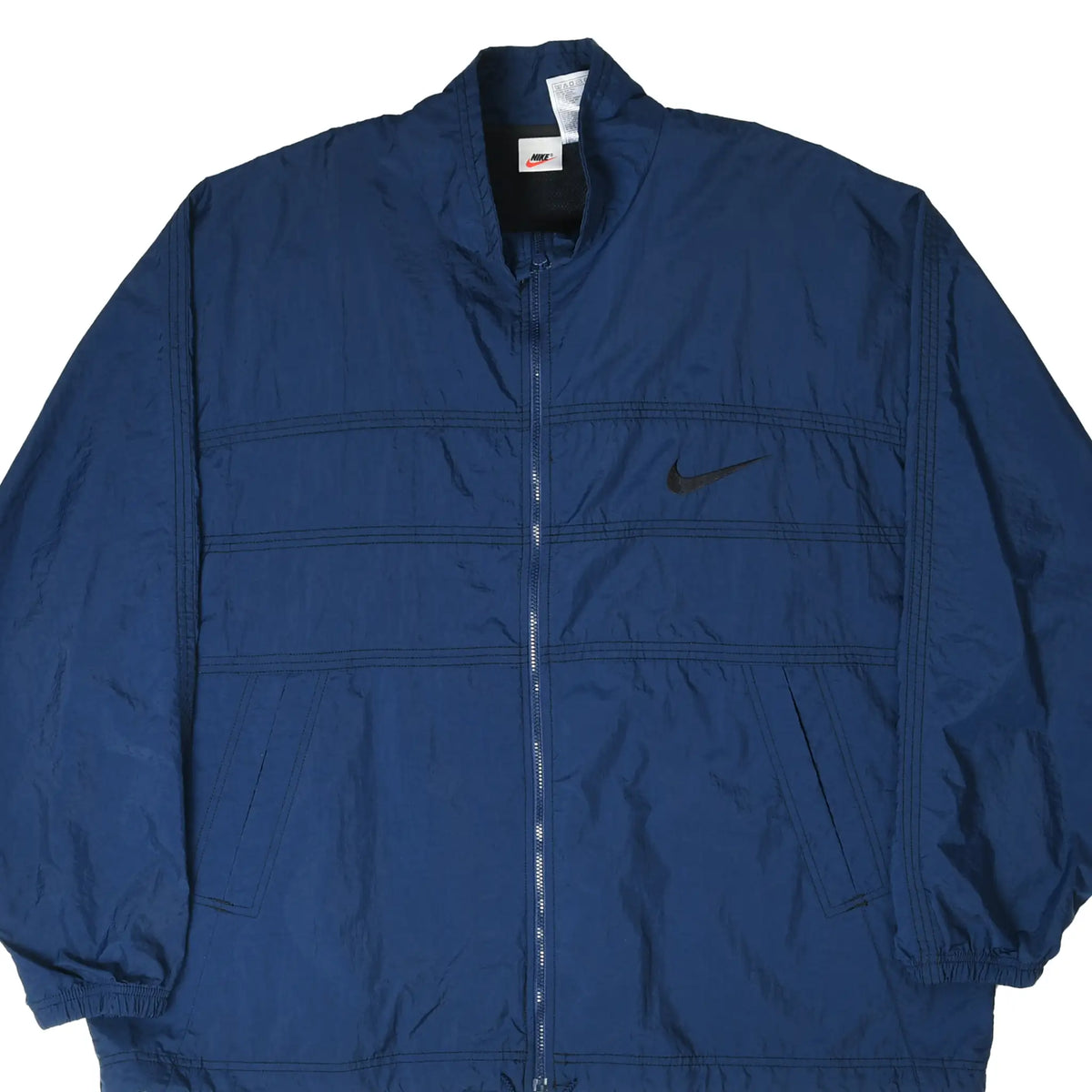 Front of navy blue Nike windbreaker jacket with black embroidered Swoosh and zip closure