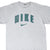 Front of grey Nike T-shirt with green outlined spellout and Swoosh graphic