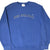 Front of blue Nike sweatshirt with arched Nike Athletics chest lettering and white Swoosh