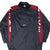 Front of black Nike pullover windbreaker with burgundy panels, white lettering and centered Swoosh