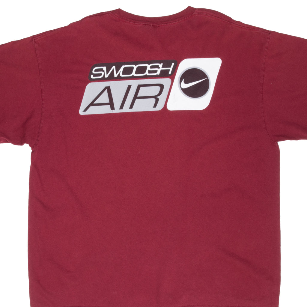 Upper back of burgundy Nike T-shirt with black, white and gray Swoosh Air graphic