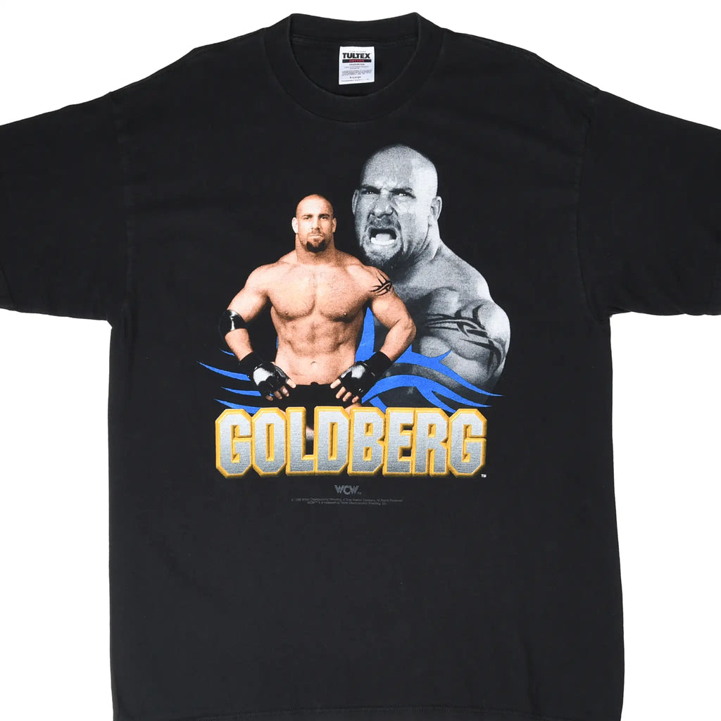 Front of black WCW T-shirt with Goldberg portraits and gold, gray, and blue name graphic