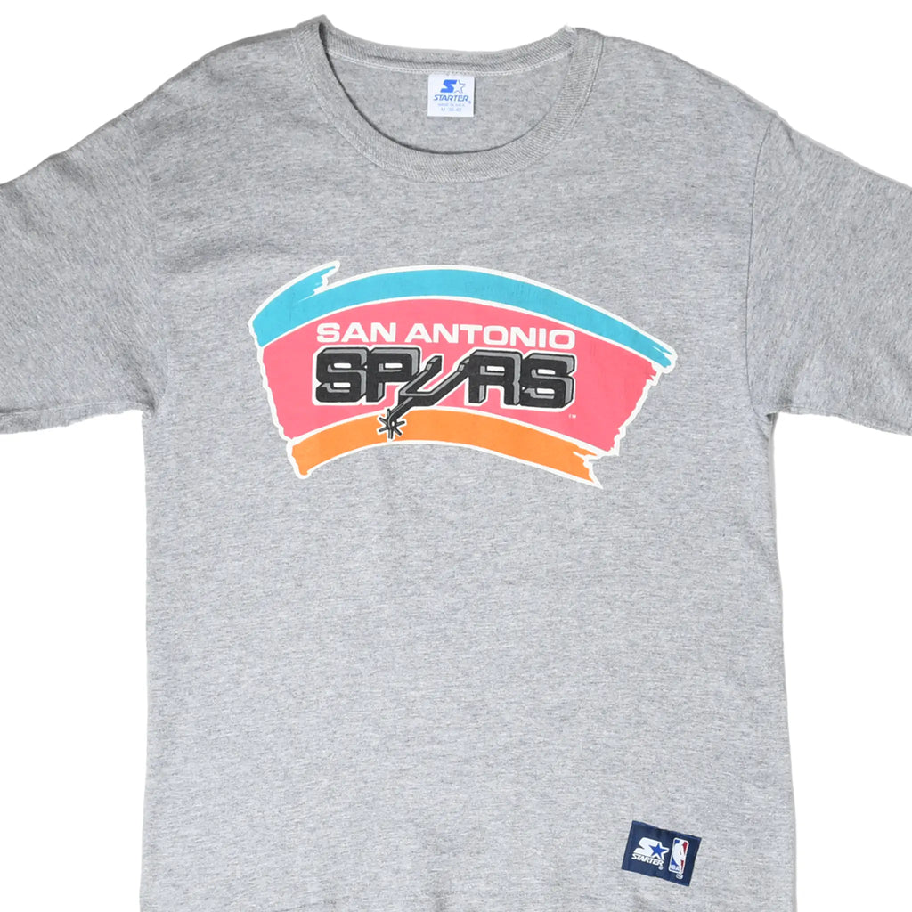 Front detail of gray Starter T-shirt with colorful San Antonio Spurs graphic and NBA hem patch