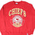 Front of red Kansas City Chiefs sweatshirt with large Chiefs crest graphic