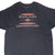 Front upper view of black Harley-Davidson T-shirt with orange, gray and white slogan graphic