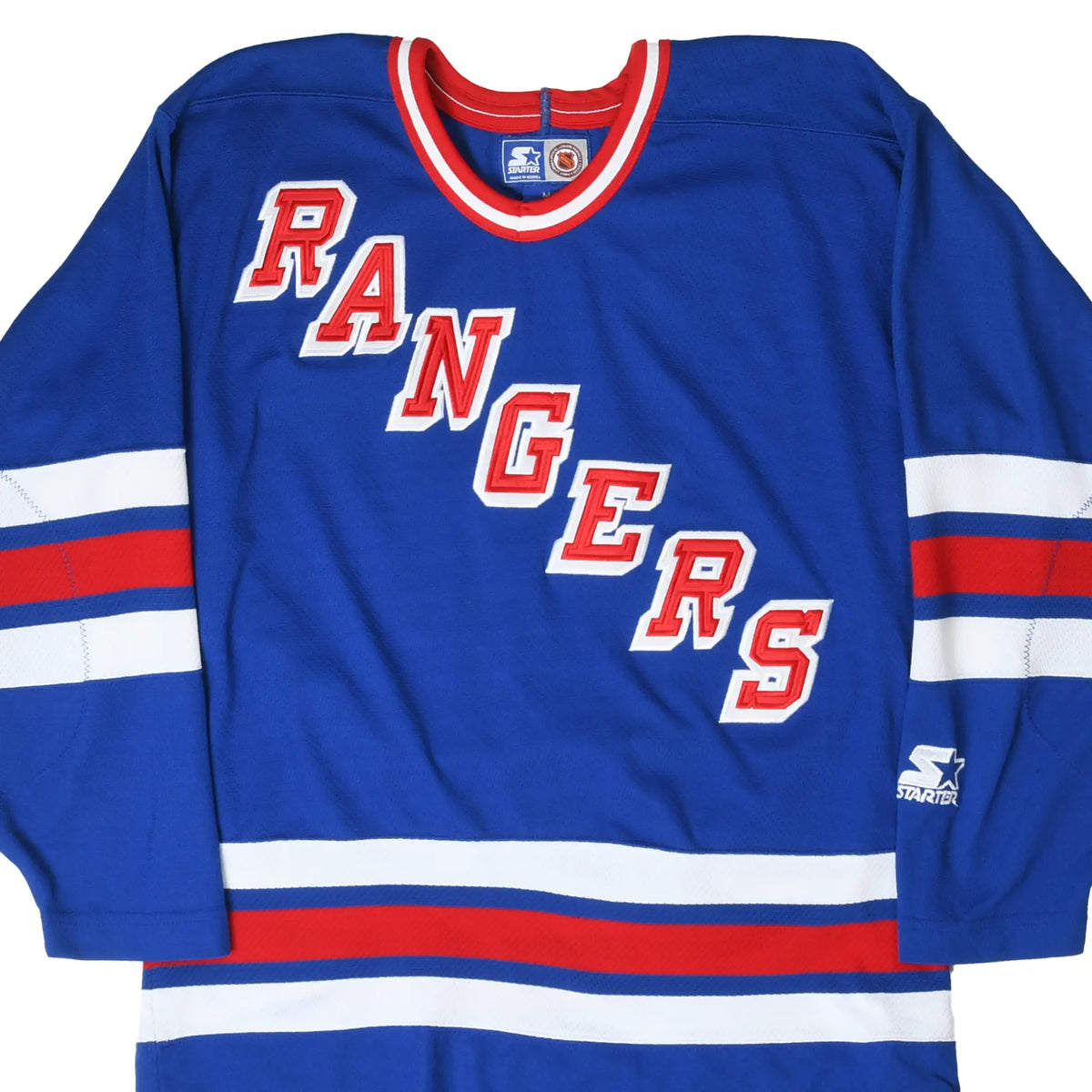 Front of blue New York Rangers Starter hockey jersey with red and white lettering and stripes