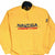 Front of yellow Nautica Competition quarter-zip fleece with navy and red embroidered logo