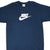 Front of navy blue Nike T-shirt with white spellout and Swoosh graphic