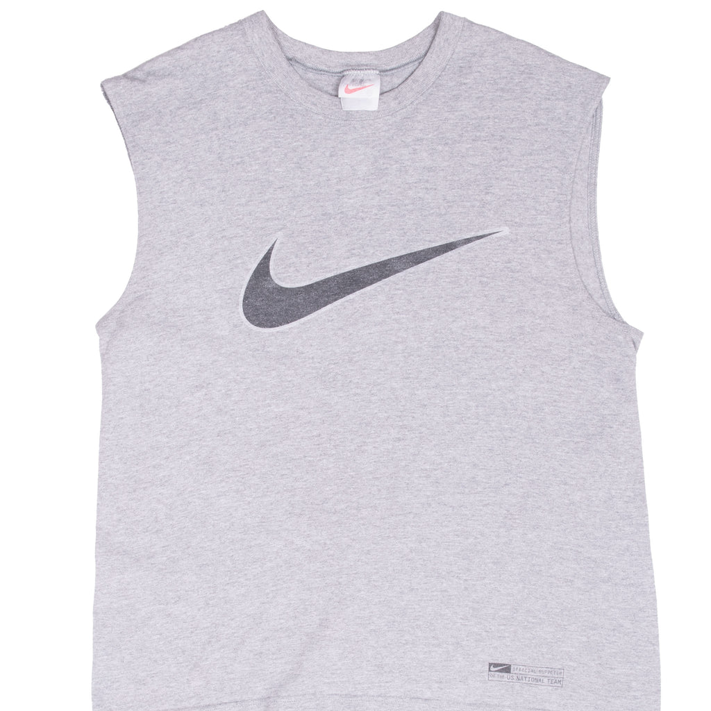 Front of grey Nike soccer tank top with large dark Swoosh and small hem graphic