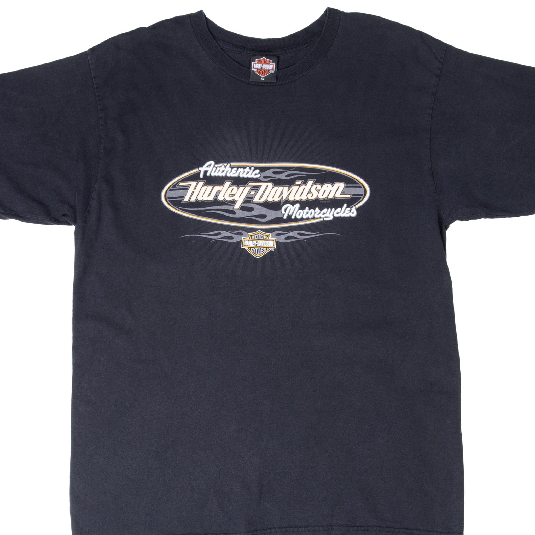 Upper front of black Harley-Davidson T-shirt with oval flame graphic and Bar & Shield logo