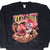 Front of black Kansas City Chiefs sweatshirt with player bursting through a football graphic