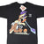 Front of black Looney Tunes T-shirt with Wile E. Coyote and Road Runner graphic and attached hangtag