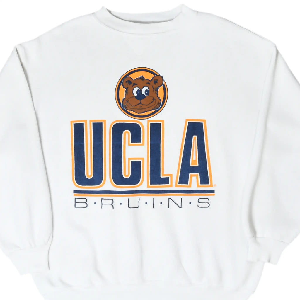 Front detail of white UCLA Bruins sweatshirt with bear mascot and navy-and-gold print