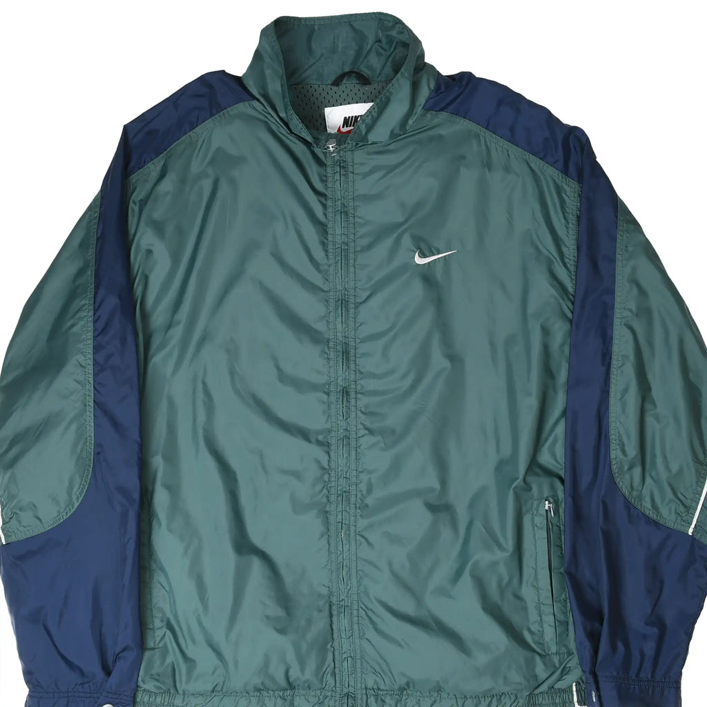 Front close-up of green and navy Nike windbreaker with white Swoosh embroidery